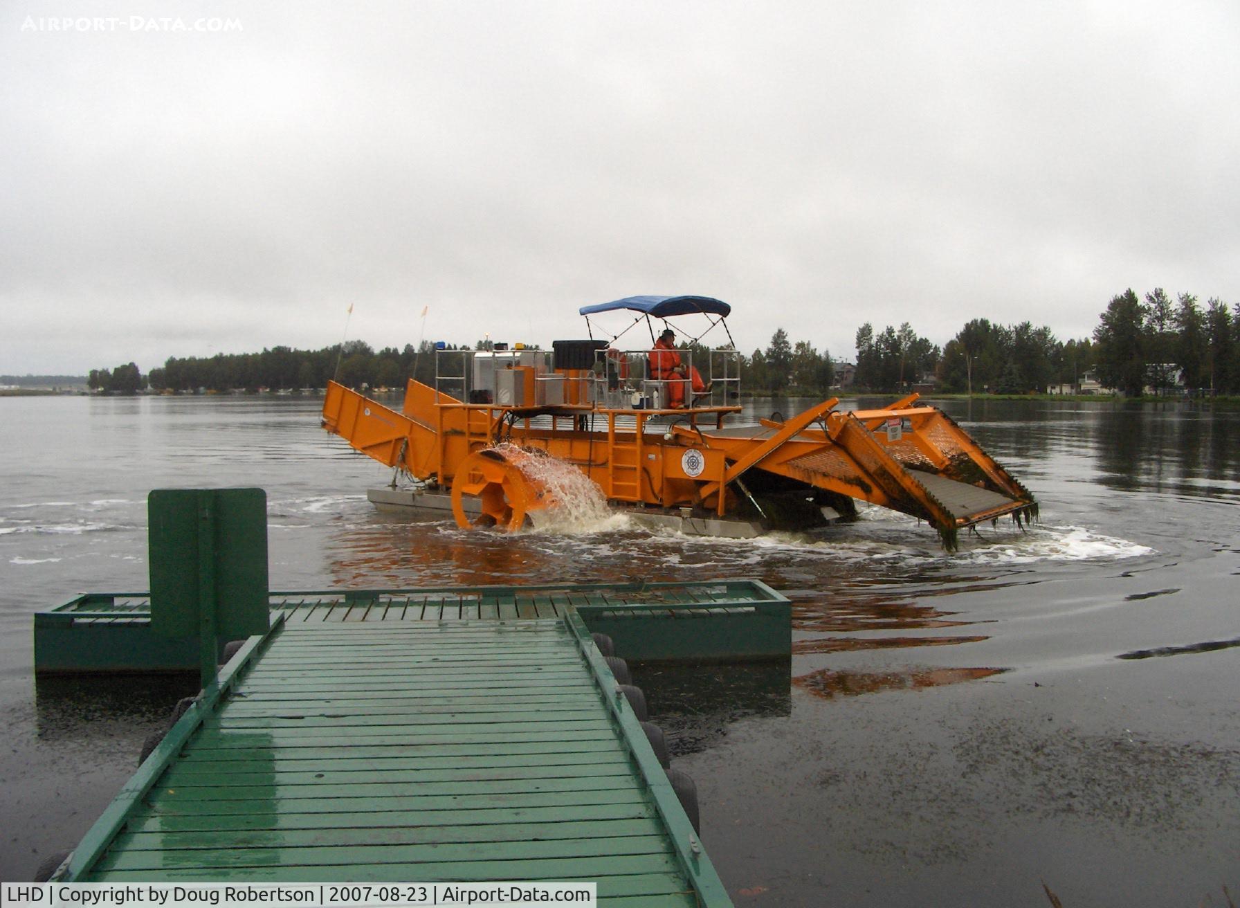 Lake Hood Seaplane Base (LHD) - Lake Hood SPB's water weed cutter/scooper keeping busy clearing taxi lanes-scooper raised