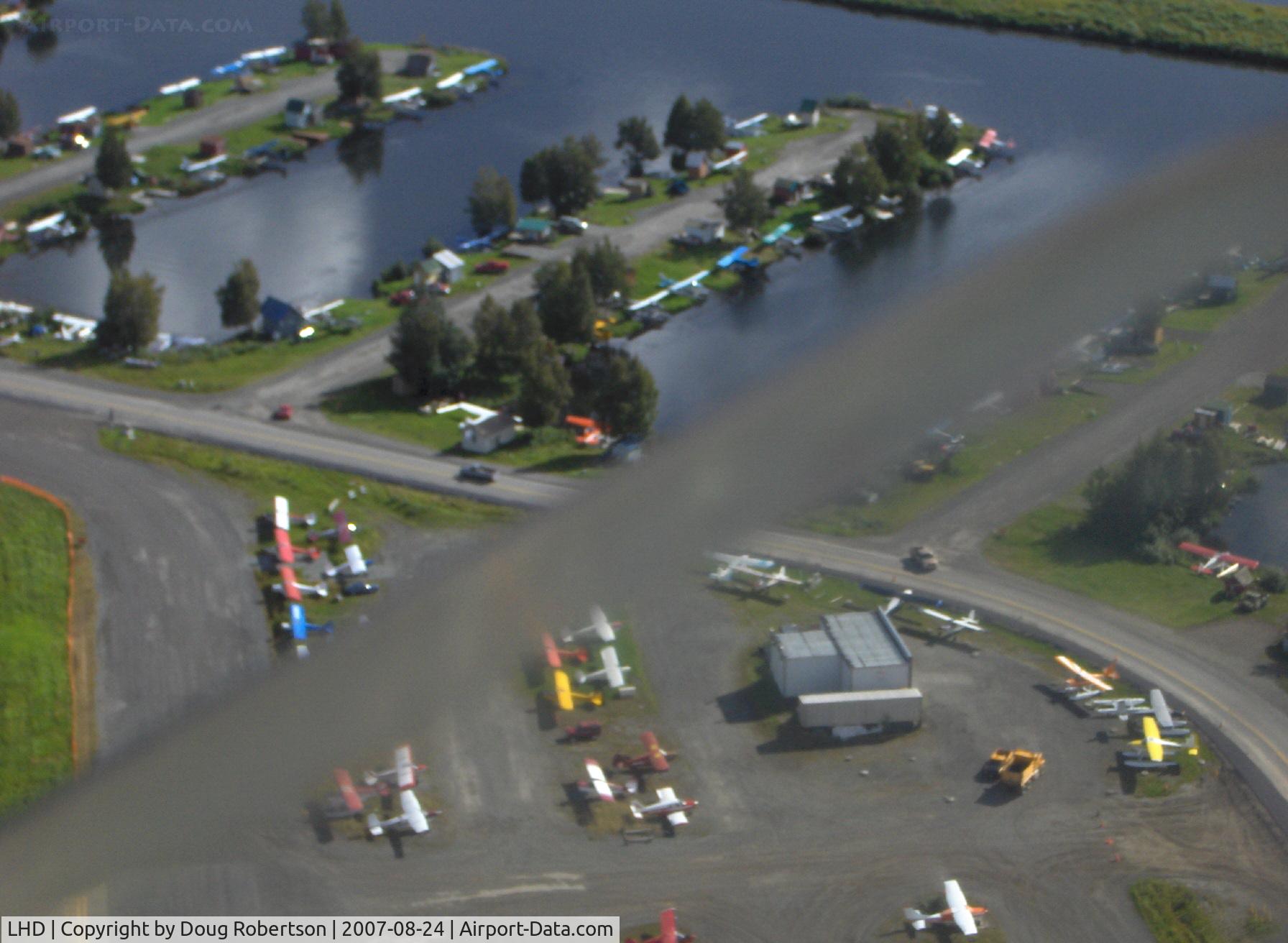 Lake Hood Seaplane Base (LHD) - Float planes at Lake Hood SPB, taken from DHC-2 Beaver floatplane N4444Z enroute to LHD for landing. Diagonal blur is copilot's down window edge.