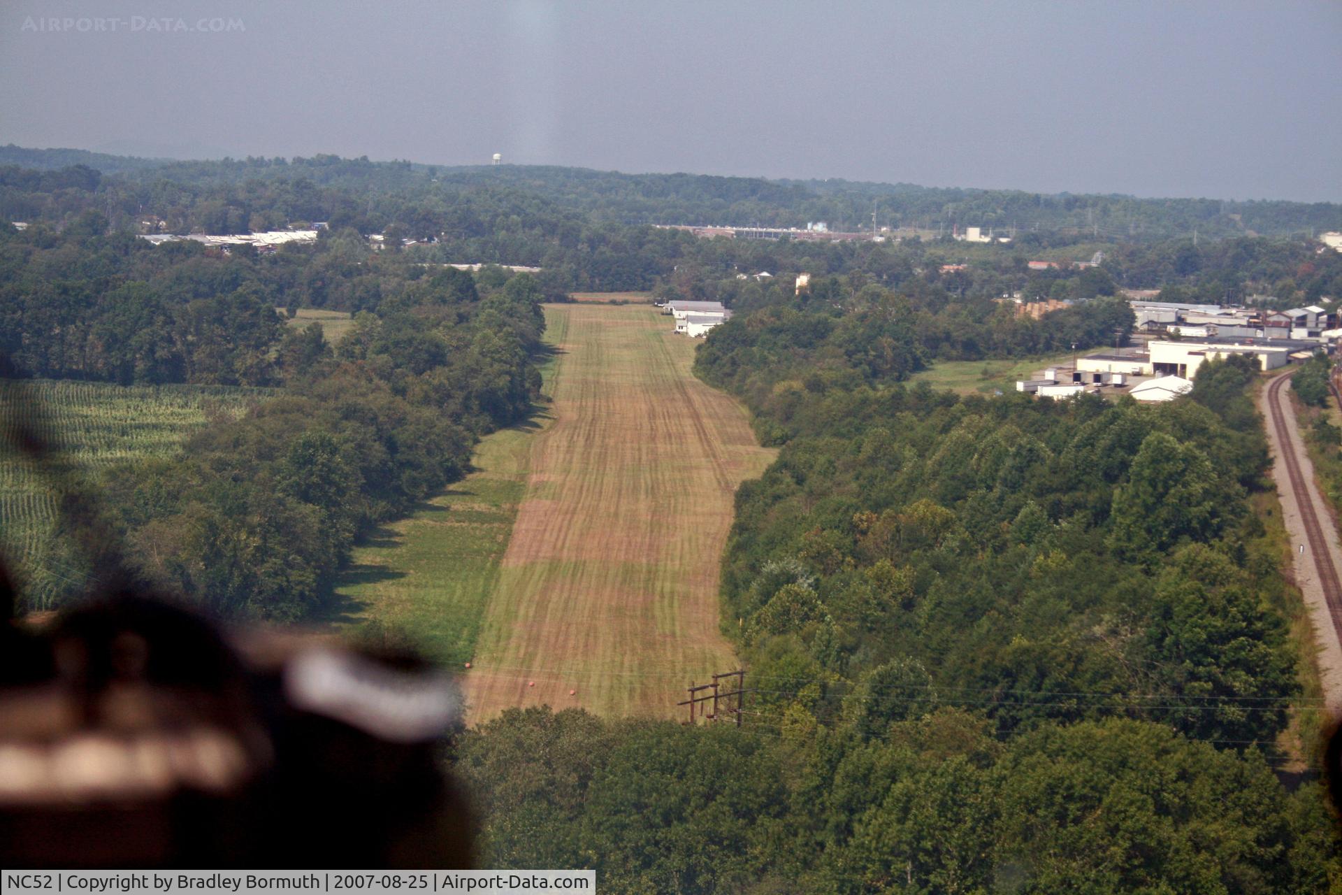 Silver Creek Airport (NC52) - Approaching runway 27 for landing.  Note the power lines on the approach end of this runway.