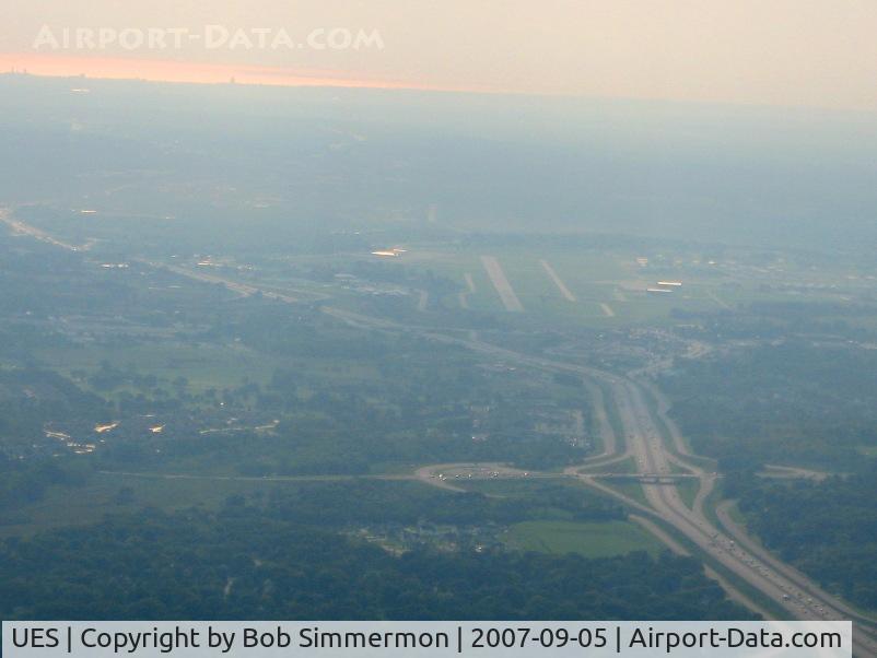 Waukesha County Airport (UES) - Looking east from 2500' with Lake Michigan reflecting the morning sun in the distance.