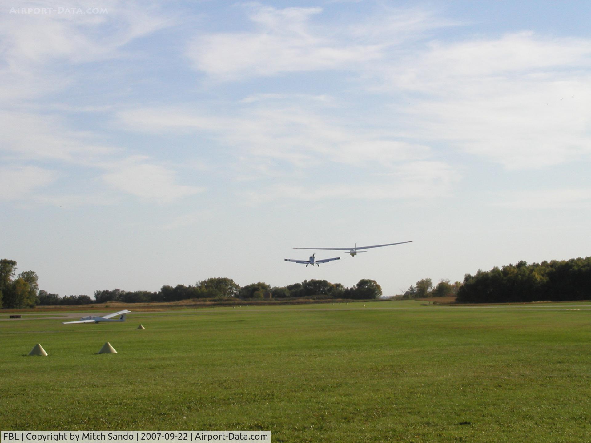 Faribault Municipal Airport (FBL) - 312RA towing 6156J off of Runway 20 at Faribault.