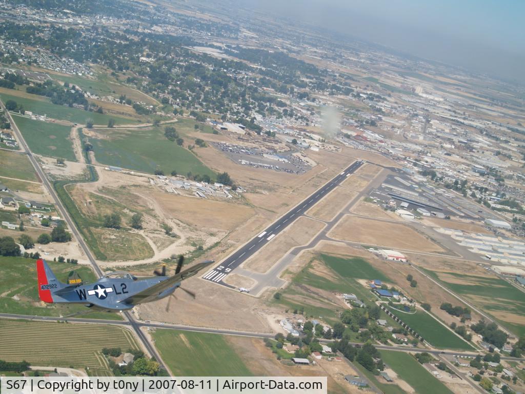 S67 Airport - A P-40 and p-51 in formation over S67 during the Warhawk Air Museum's B-25 days.