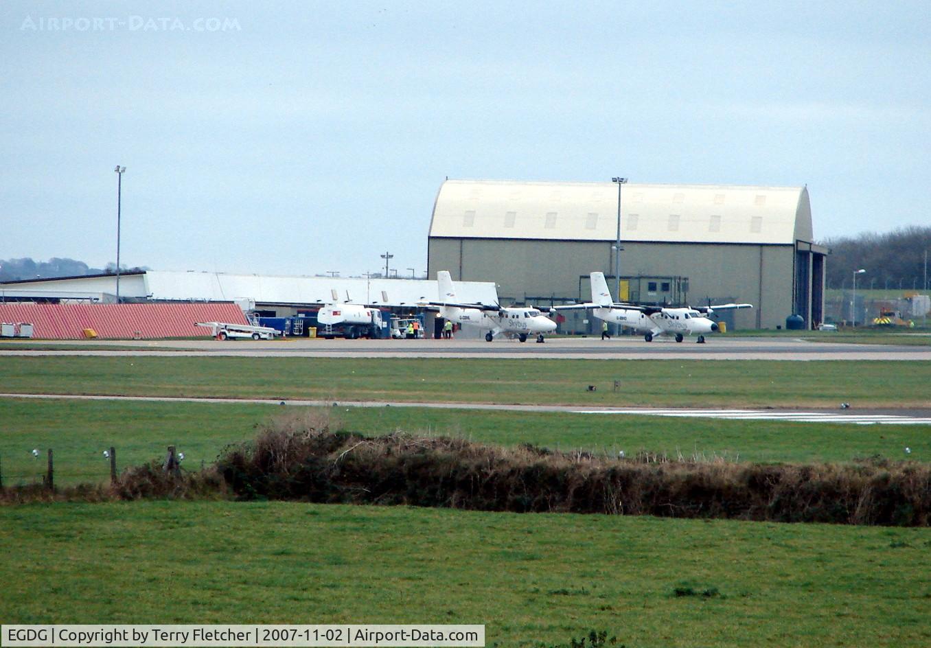 Newquay Cornwall International Airport / RAF St. Mawgan, Newquay, England United Kingdom (EGDG) - Two Skybus Twin Otters on the apron waiting to start the days work