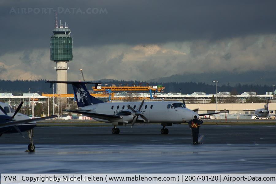 Vancouver International Airport, Vancouver, British Columbia Canada (YVR) - Winter time : Beech 1900 from Pacific Coastal at the South Terminal - Control Tower in the background
