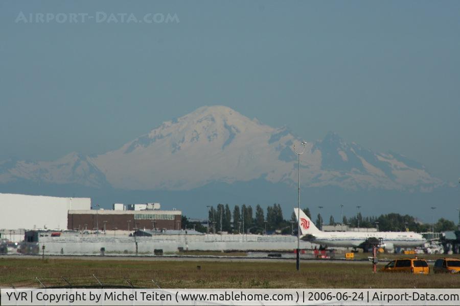 Vancouver International Airport, Vancouver, British Columbia Canada (YVR) - Mount Baker, in the Washington State can be seen over YVR (and seems closer than it actually is) with a 767 from Air China on the right