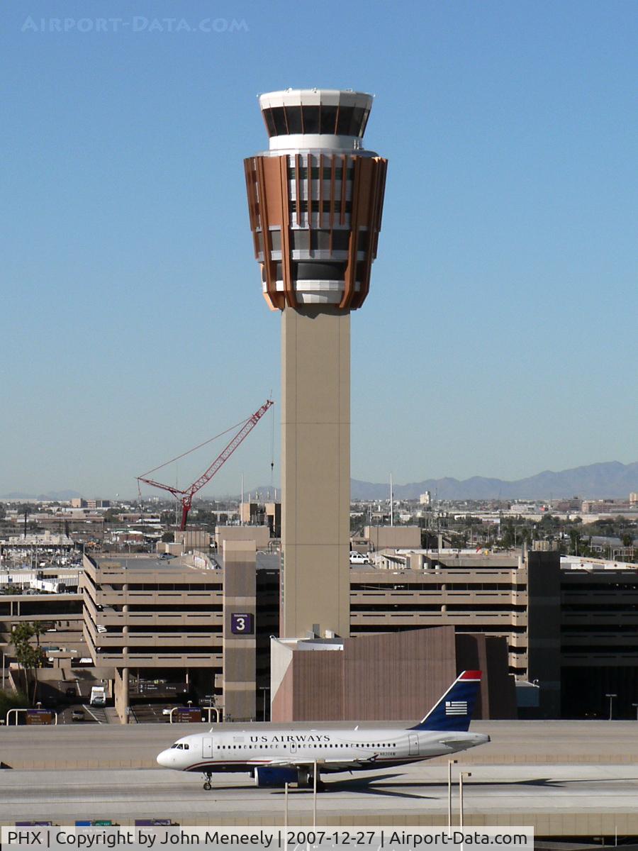 Phoenix Sky Harbor International Airport (PHX) - Good definition of scale between the A319 and the new control tower. The crane in the background is dismantling the old tower.