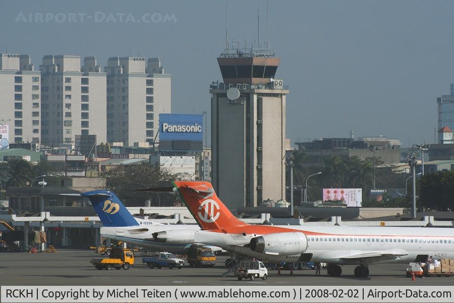 Kaohsiung International Airport, Kaohsiung City Taiwan (RCKH) - The old control tower over the domestic terminal with the tail of a F100 from Mandarin Airlines and an MD-90 from Uni Air