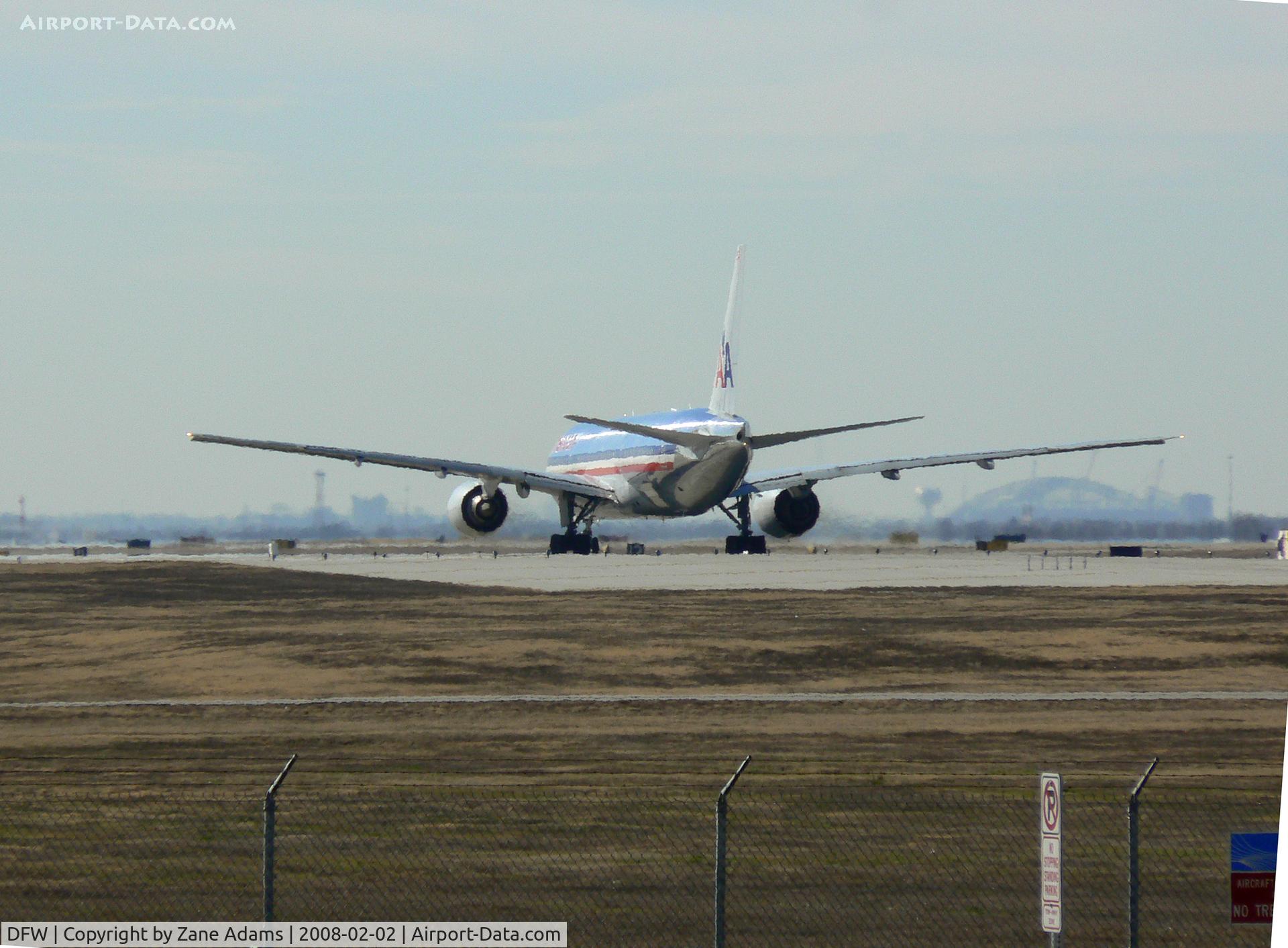 Dallas/fort Worth International Airport (DFW) - American Airlines 757 in position and holding 17L - Notice the new Dallas Cowboys Staduim under construction 15 miles south, in Arlington, under the right wing