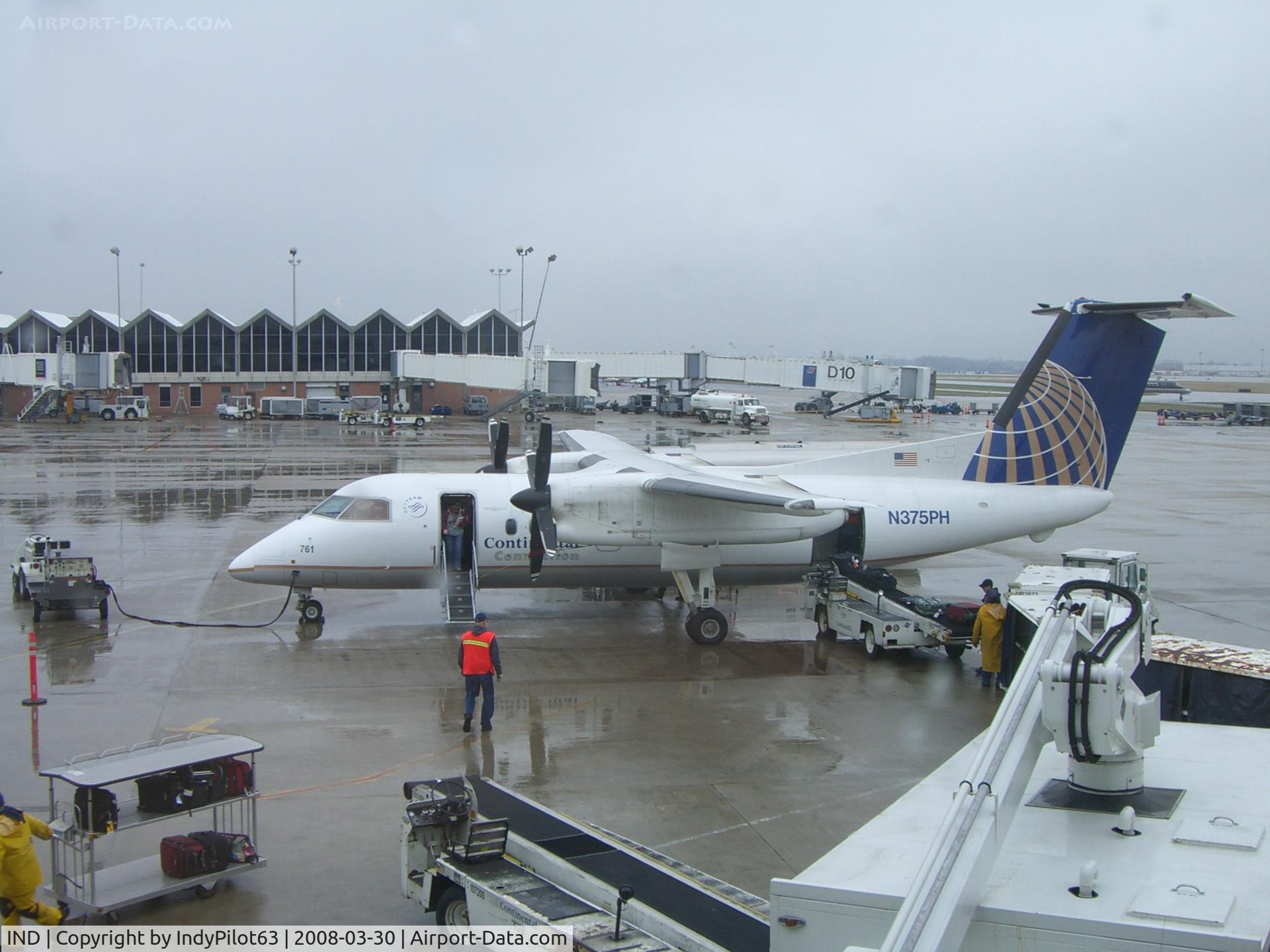 Indianapolis International Airport (IND) - A Dash-8 with the main terminal in the backround