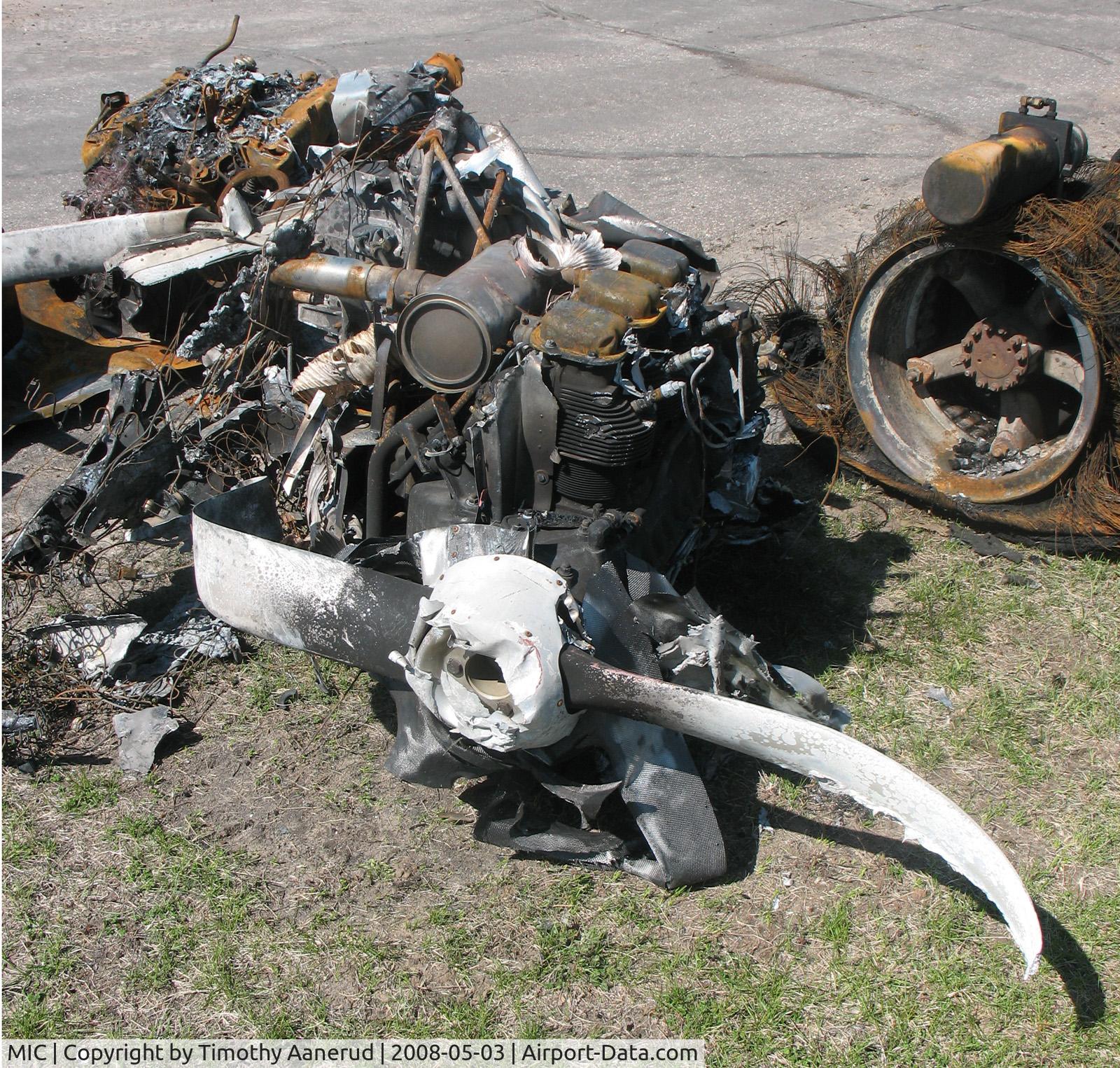 Crystal Airport (MIC) - A tail dragger with a six cylinder Continential after a hangar fire on 27 April 2008.