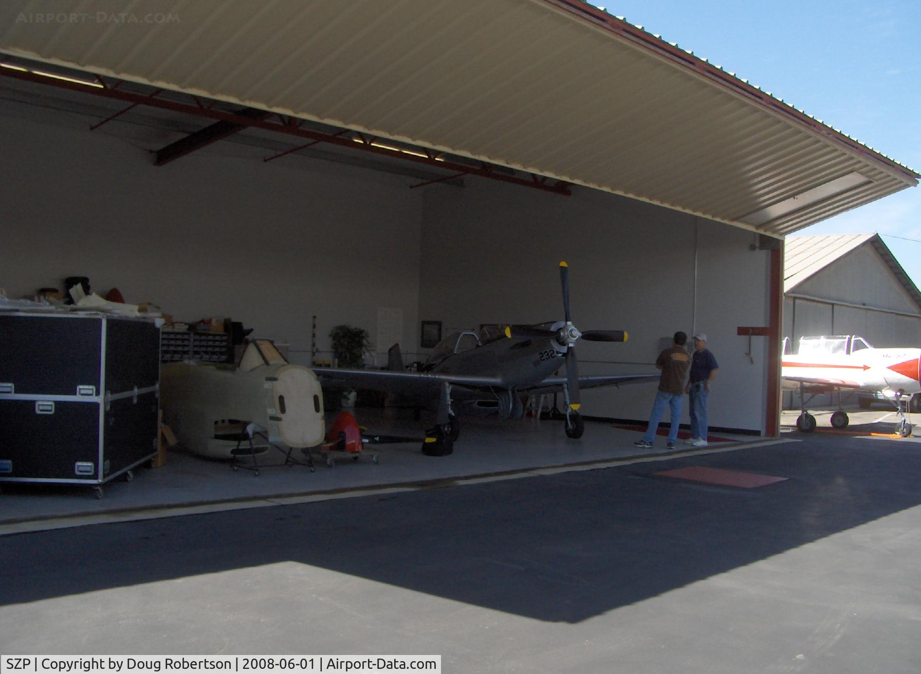 Santa Paula Airport (SZP) - Legendary Aircraft LLC, 70% scale TF-51, P-51D MUSTANGS in Area 51. Composite molded construction with V-8 Corvette engines. N151RK shown in hangar 1 of 2. Ed Hullinger, Principal. See: www.LegendaryAircraft.com