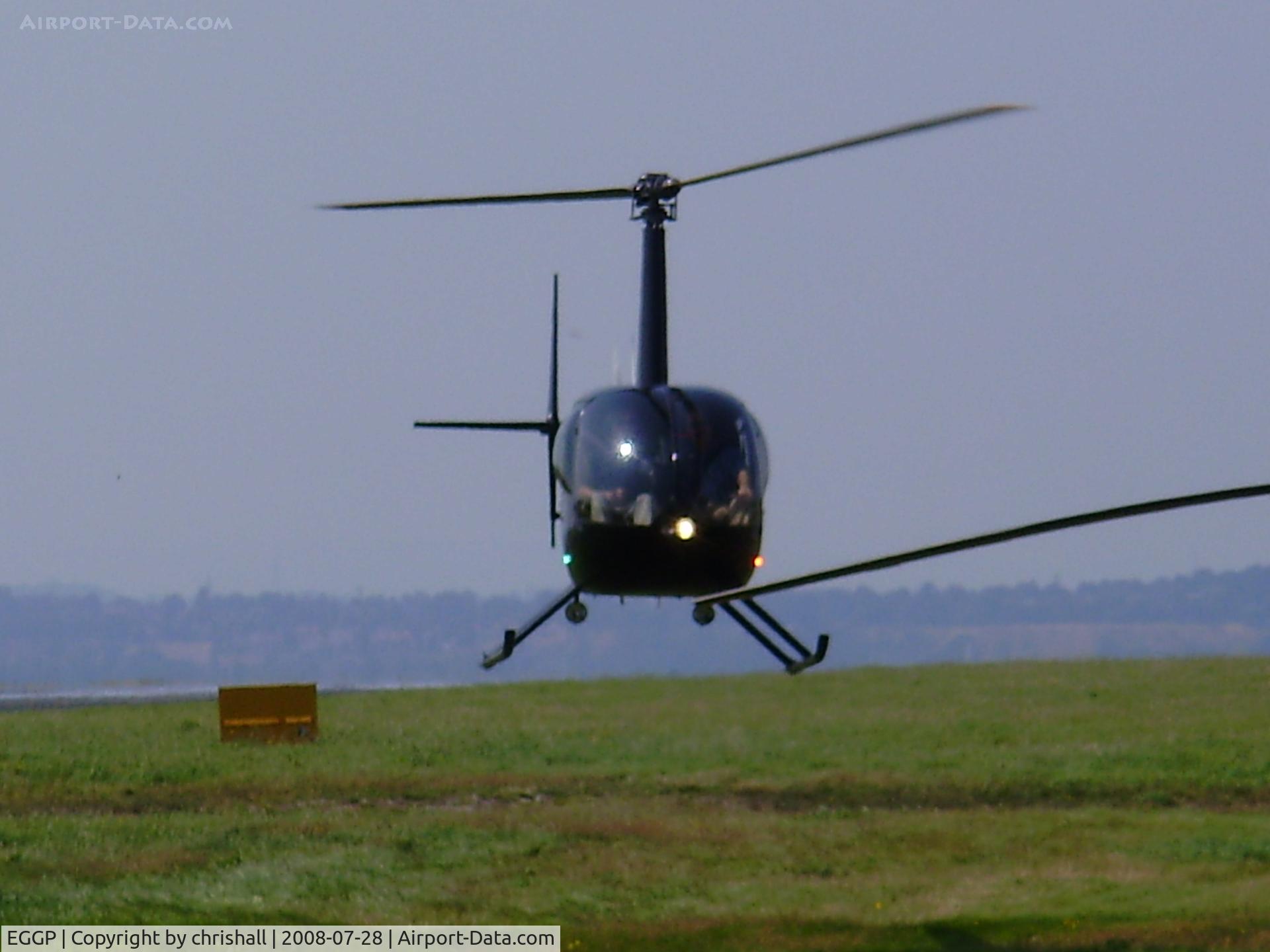 Liverpool John Lennon Airport, Liverpool, England United Kingdom (EGGP) - Robinson R22 hovering near the GA apron