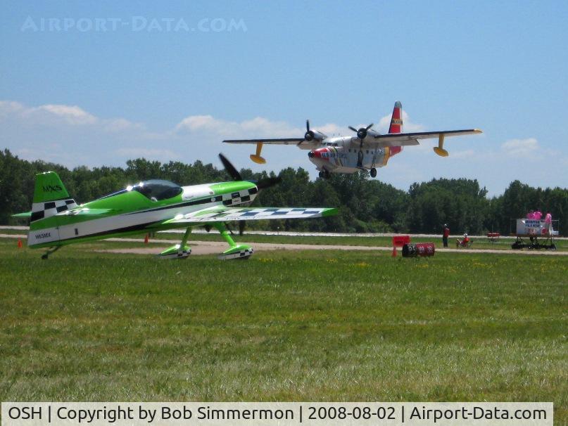 Wittman Regional Airport (OSH) - N65MX & N266GR landing RWY 36 and the controllers in their pretty pink T-shirts.