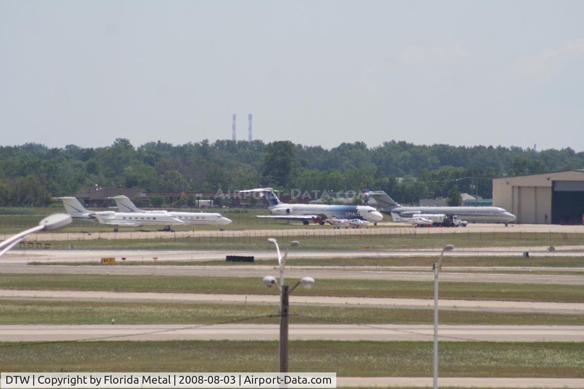 Detroit Metropolitan Wayne County Airport (DTW) - Looking across Runways 3R/21L and 3L/21R at an ex Spirit MD80, Detroit Pistons DC-9 and several private jets