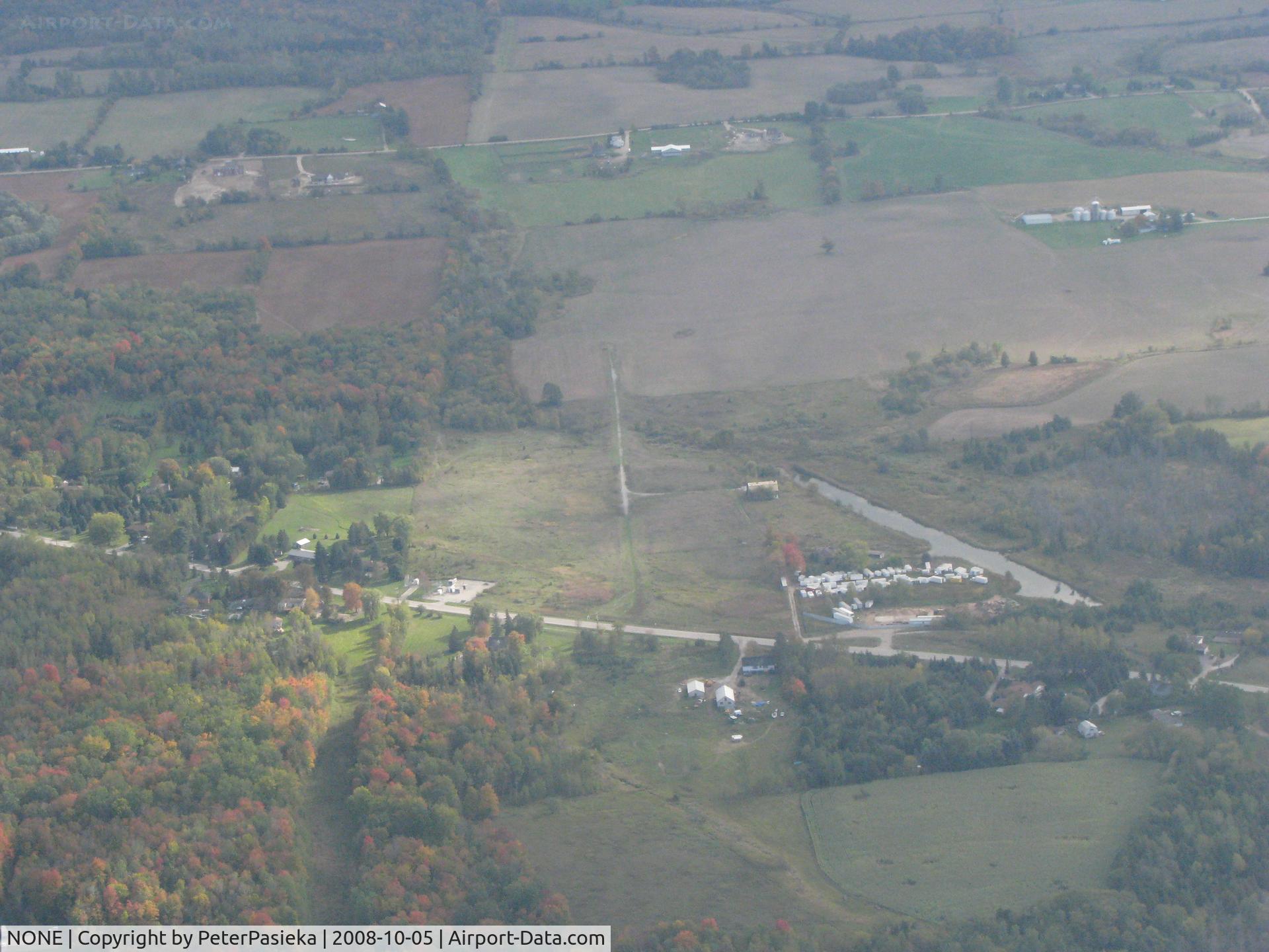 NONE Airport - Pottageville, Ontario Canada. The narrow gravel strip is what is left over after an attempt to have an airport. The water ditch was dug to allow float-equiped aircraft to land there. The locals got together and forced the closure.