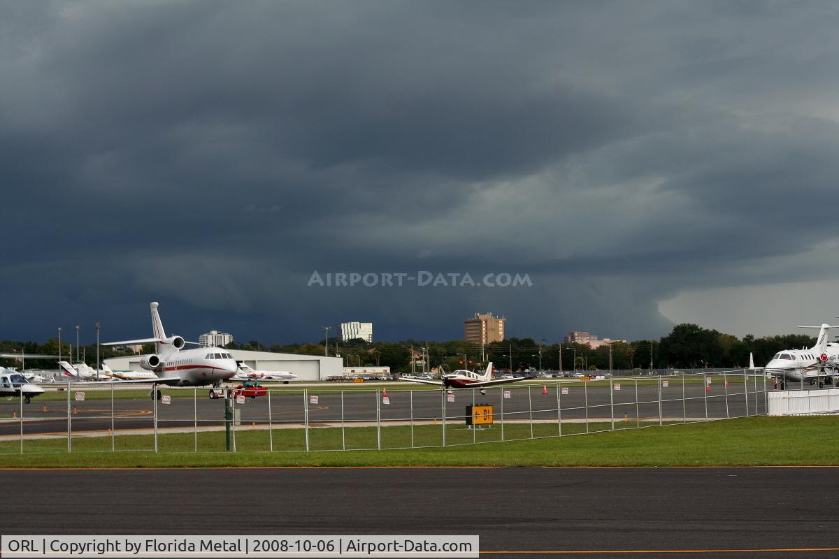 Executive Airport (ORL) - Orlando Executive Airport with Downtown Orlando and storm in background