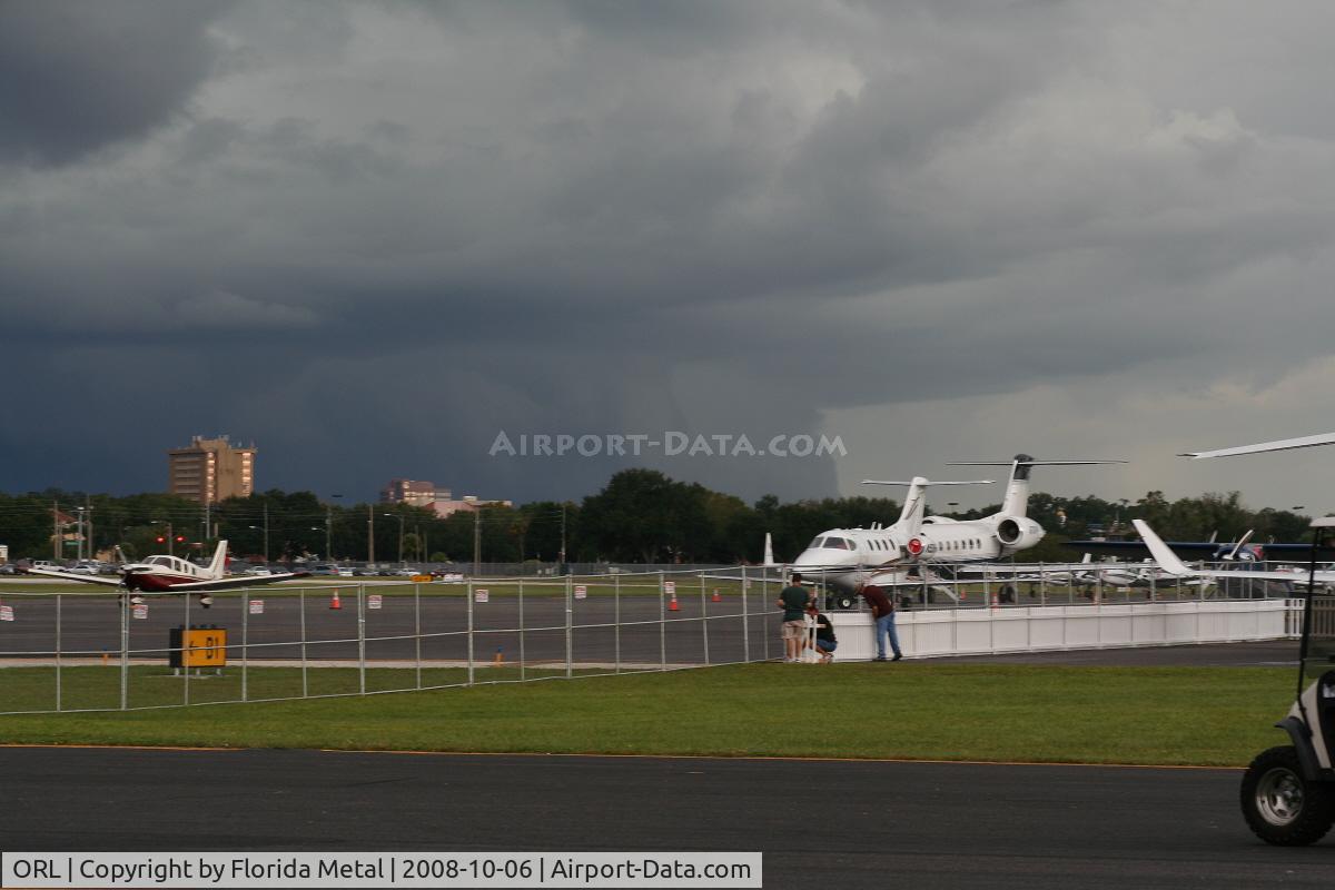 Executive Airport (ORL) - Stormclouds brewing over Downtown Orlando casting shadow on Orlando Executive Airport