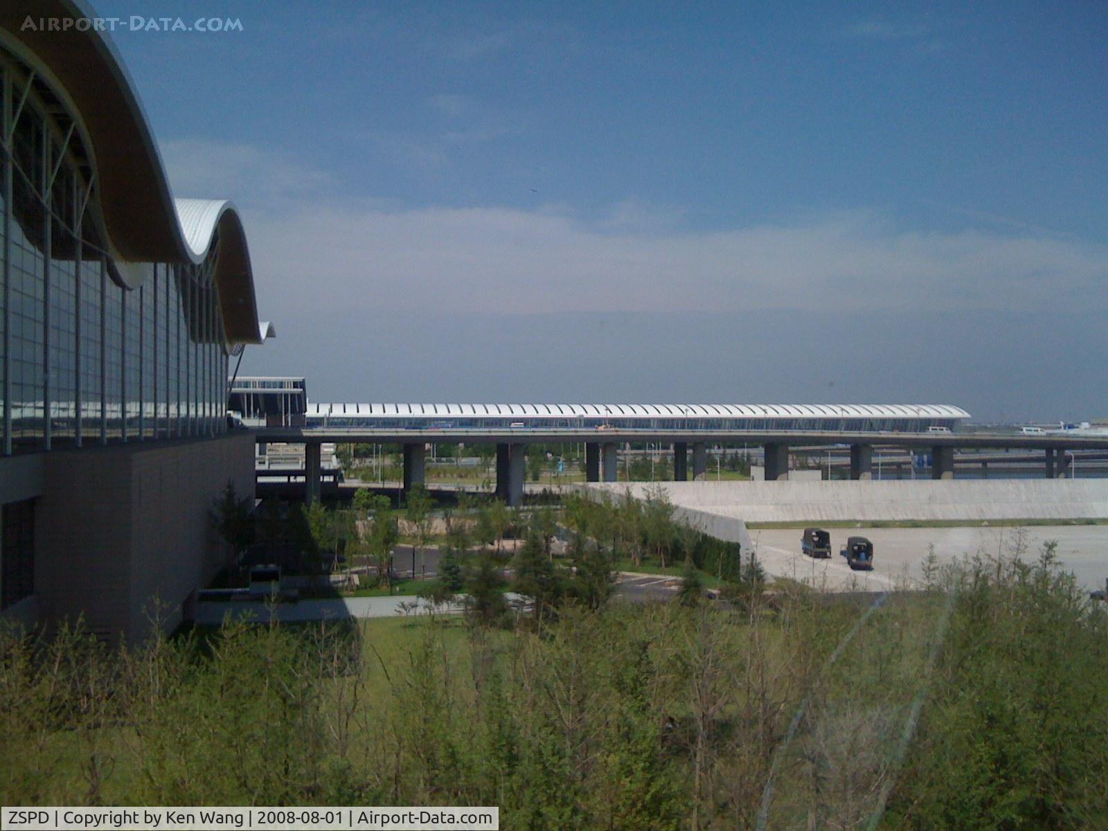 Shanghai Pudong International Airport, Shanghai China (ZSPD) - Looking at Terminal 1 from Terminal 2. Rare blue sky in Shanghai