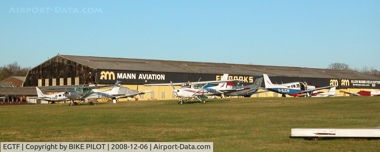 Fairoaks Airport, Chobham, England United Kingdom (EGTF) - PART OF THE AIRCRAFT PARK WITH THE ALAN MANN HANGERS IN THE BACK GROUND