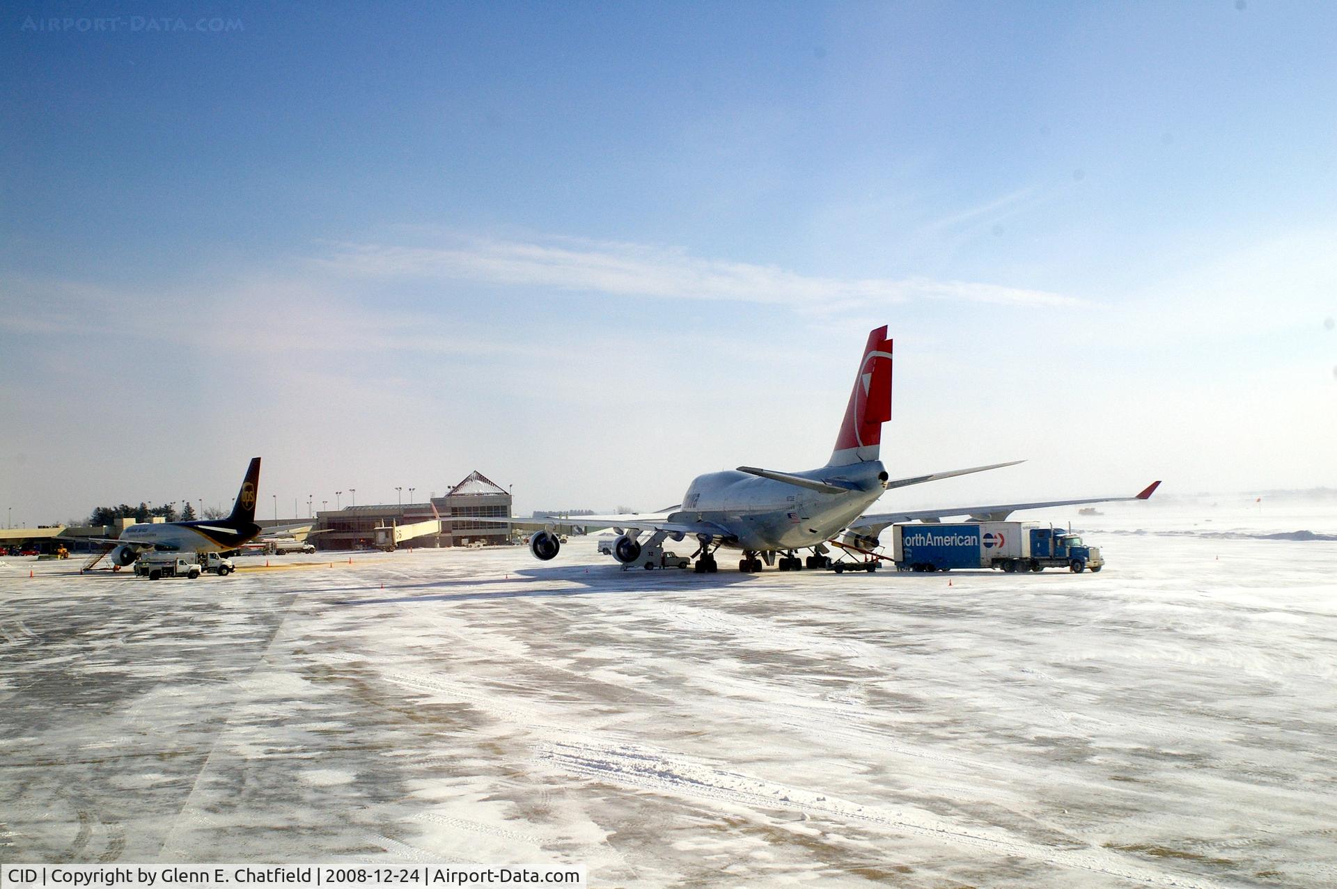 The Eastern Iowa Airport (CID) - Cold morning loading up NWA9980 with baggage from U of I football team.  10 degrees and 25-30 kt wind.  UPS 757 on the ramp