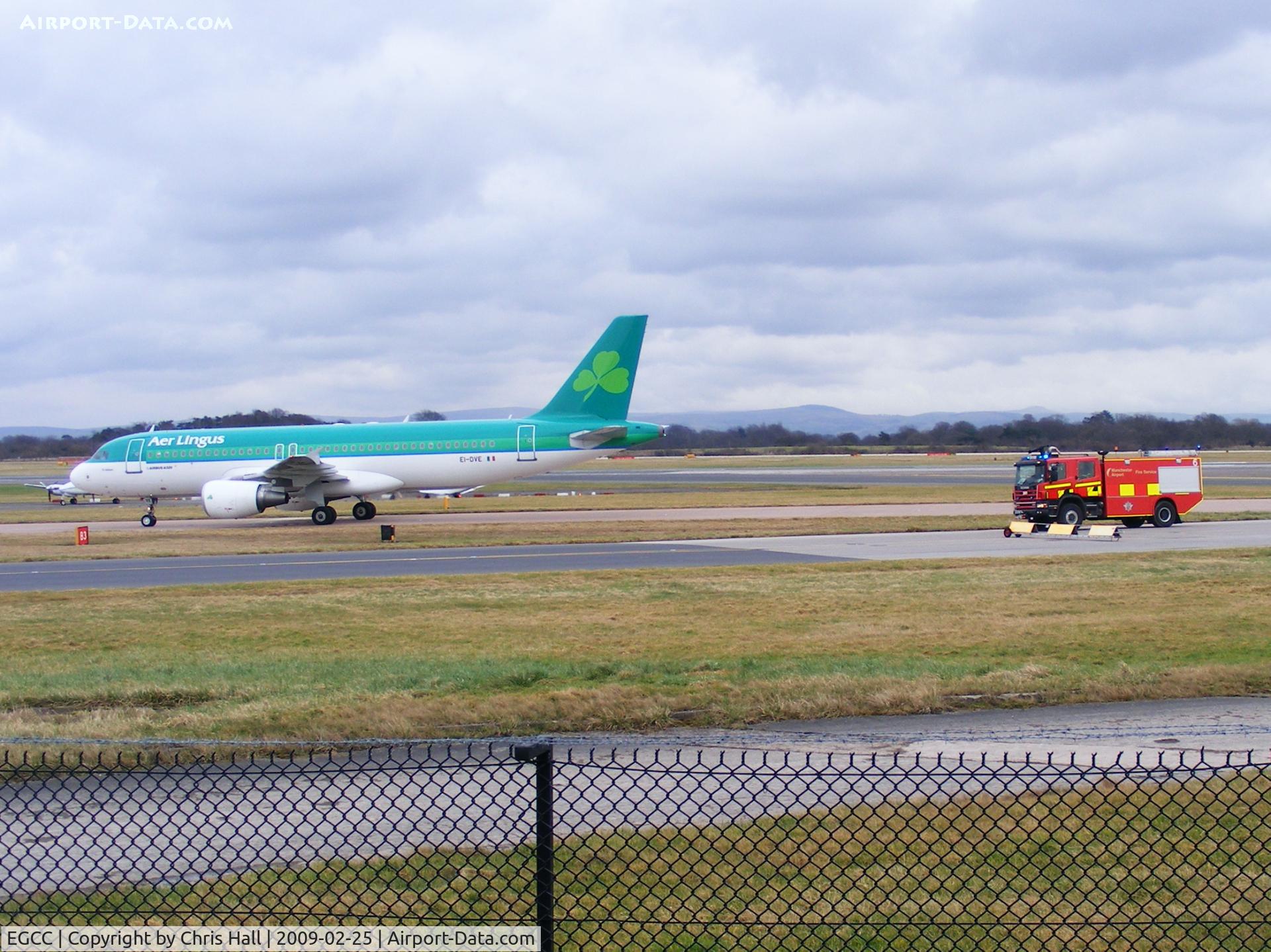 Manchester Airport, Manchester, England United Kingdom (EGCC) - Aer Lingus A320 EI-DVE being followed to the terminal by a fire truck