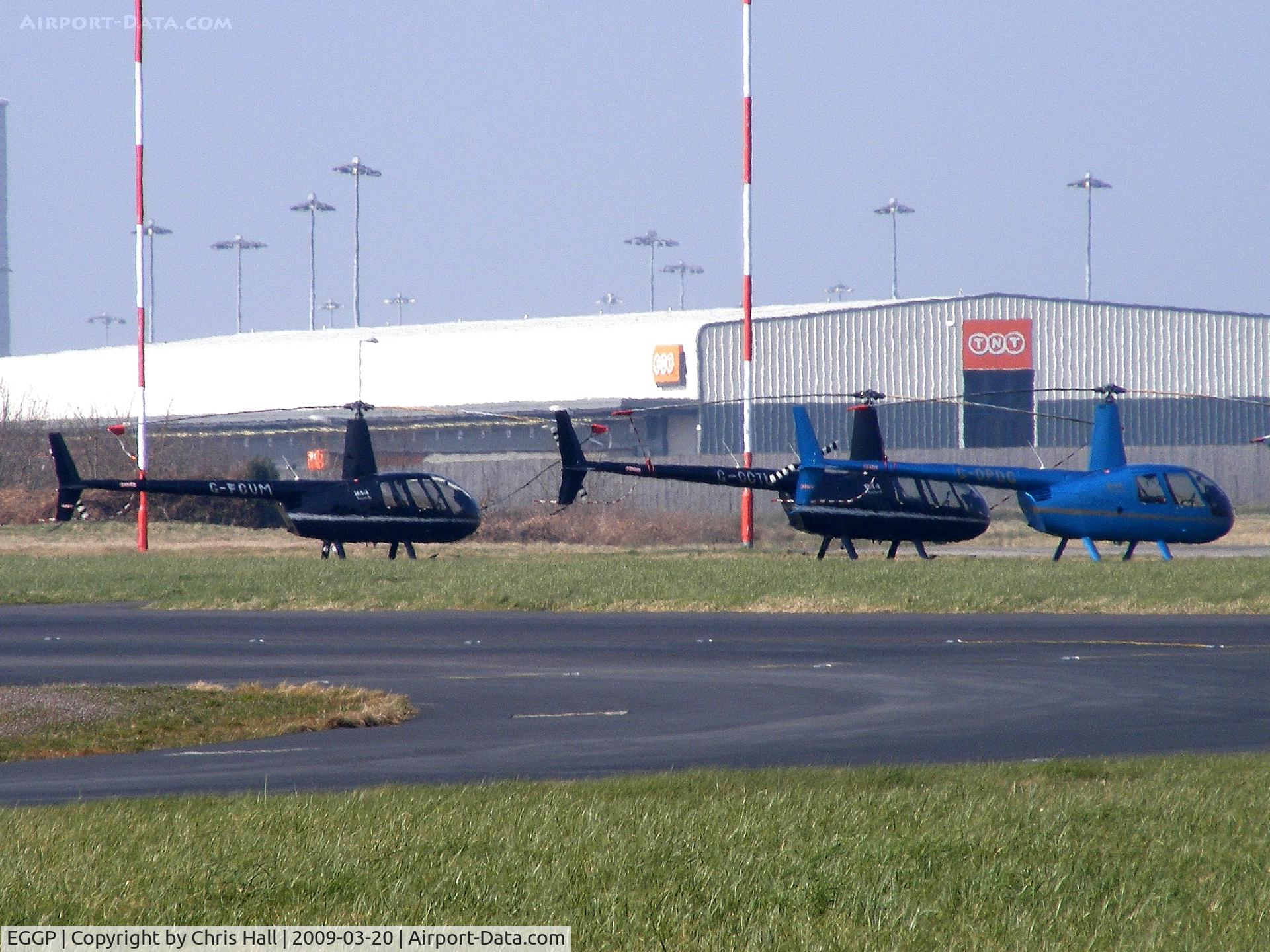 Liverpool John Lennon Airport, Liverpool, England United Kingdom (EGGP) - a lineup of Robinson R44's