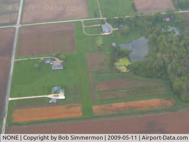 NONE Airport - Unknown N-S farm strip on W300N near Uniondale, IN. There's a nice high-wing mural painted on the hanger door.