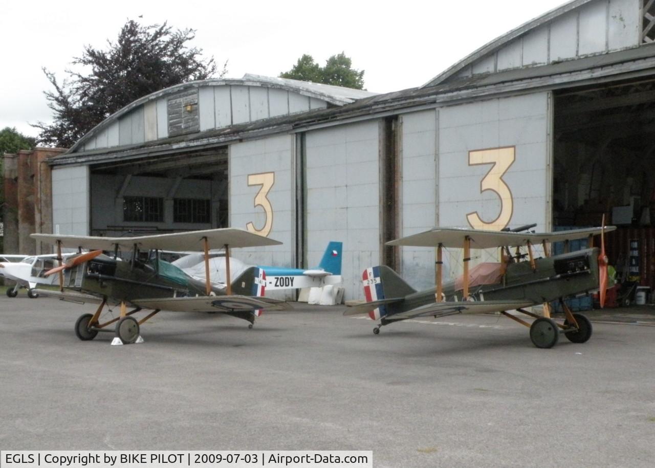 Old Sarum Airfield Airport, Salisbury, England United Kingdom (EGLS) - TWO REPLICA WW I SE5A'S IN FRONT OF GENUINE WW I BELFAST HANGERS