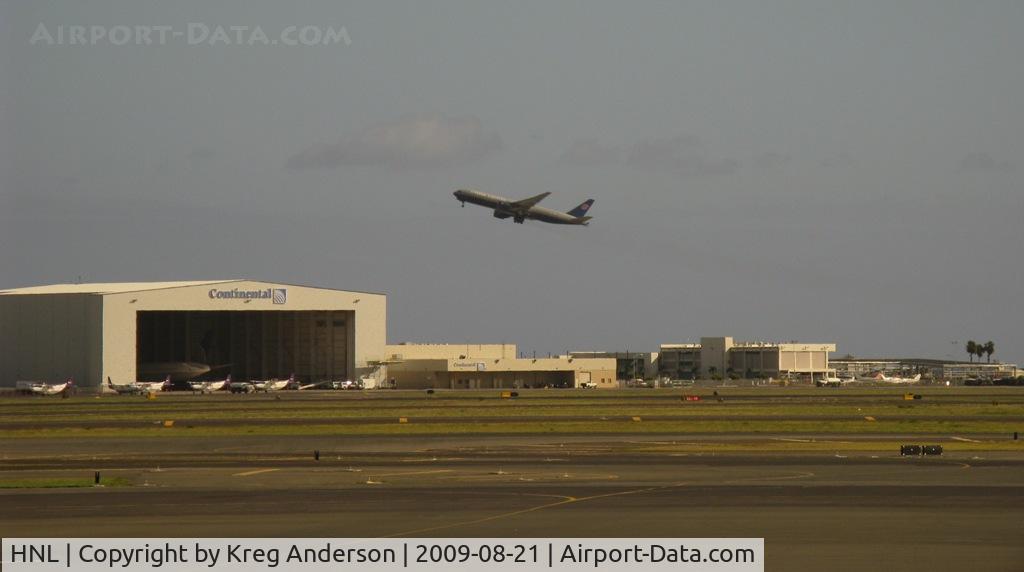 Honolulu International Airport (HNL) - A view of the Continental Hangar as a UA 777 flies over.