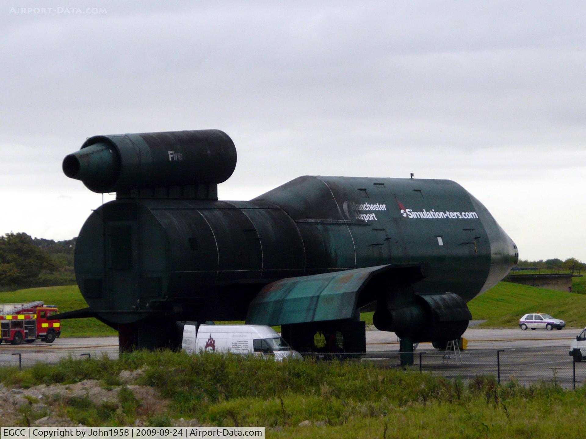 Manchester Airport, Manchester, England United Kingdom (EGCC) - The airports fire practice simulator, looking well used!!