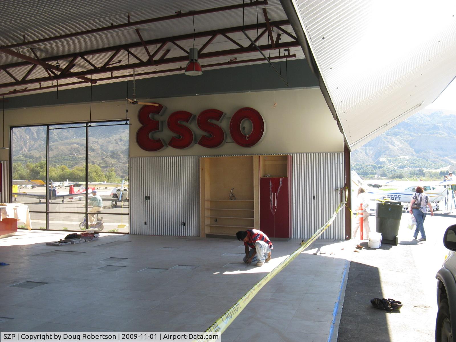 Santa Paula Airport (SZP) - 32 Curtiss Taxi-New hangar under construction. ESSO sign (Canadian fuel)