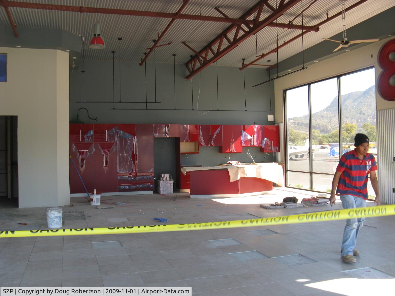 Santa Paula Airport (SZP) - 32 Curtiss Taxi-New hangar under construction. Matching red full kitchen cabinets in installation.