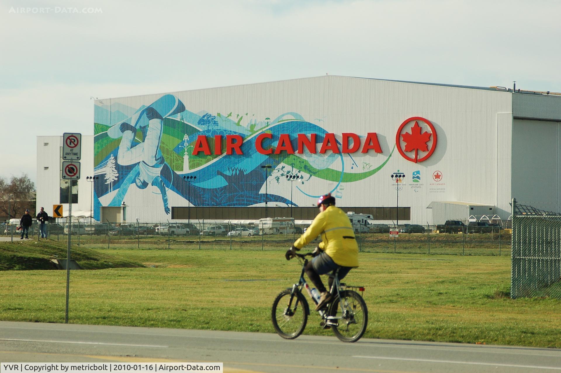 Vancouver International Airport, Vancouver, British Columbia Canada (YVR) - The Air Canada hangar at YVR with  Vancouver 2010  Olympics  decoration.Note the two spotters on the left