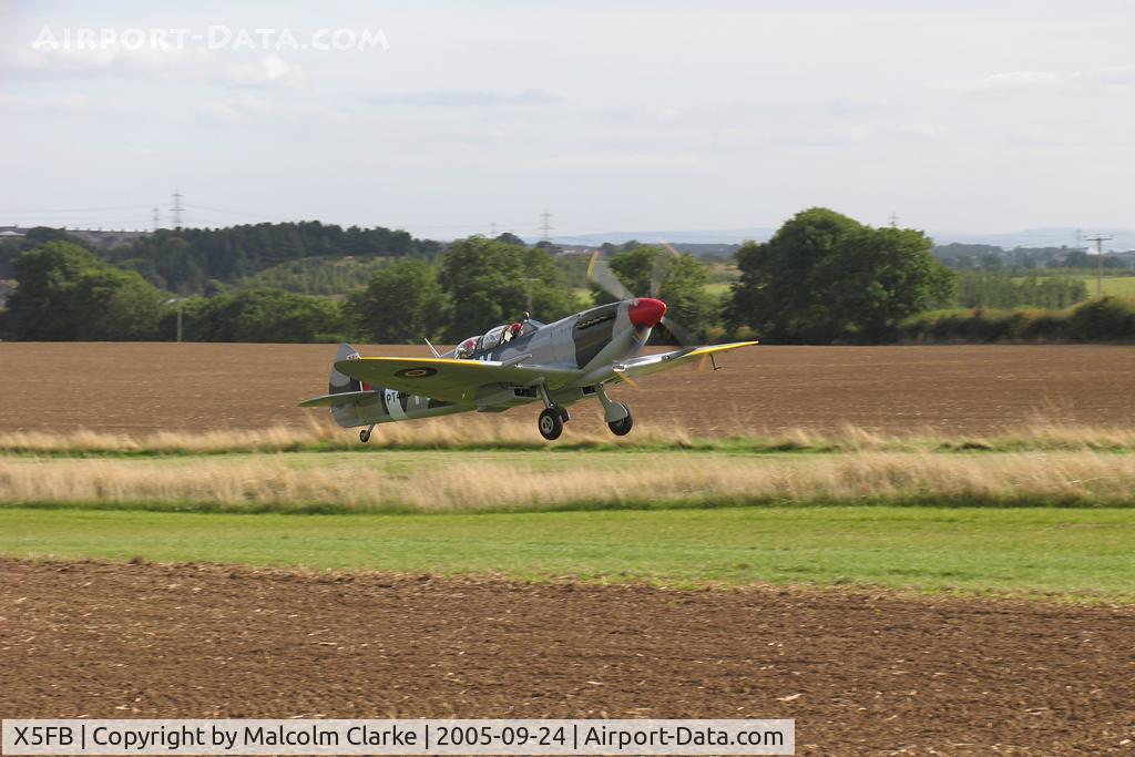 X5FB Airport - With the runway specially extended, Spitfire G-CTIX lifts off the runway upslope during the VE Day celebrations in 2005.