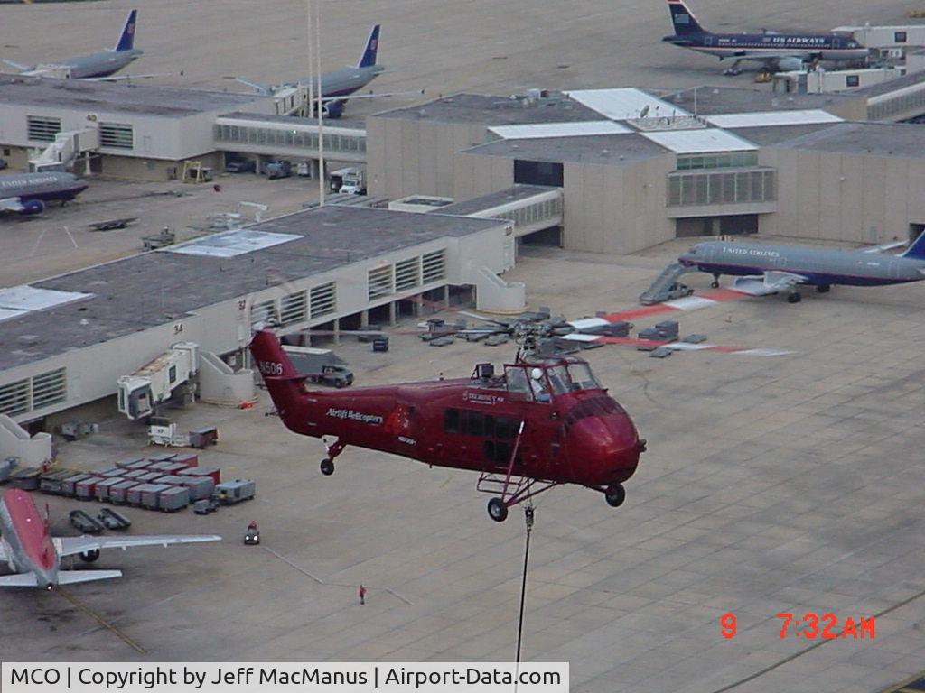 Orlando International Airport (MCO) - vintage Sikorsky lifting a new X band radar to the top of ATCT