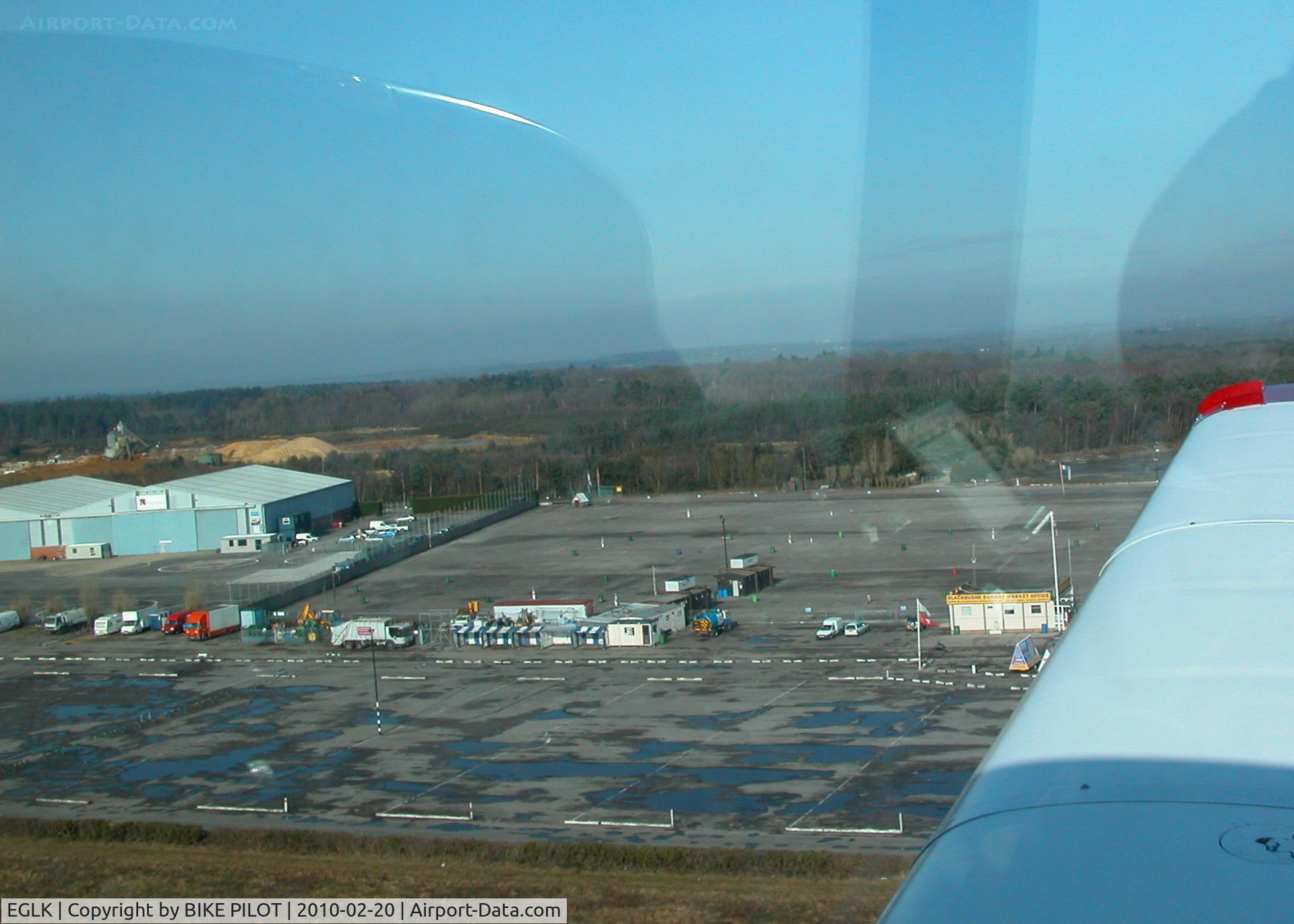 Blackbushe Airport, Camberley, England United Kingdom (EGLK) - RWY 25 CLIMB OUT PREMIAIR HANGERS ON THE LEFT