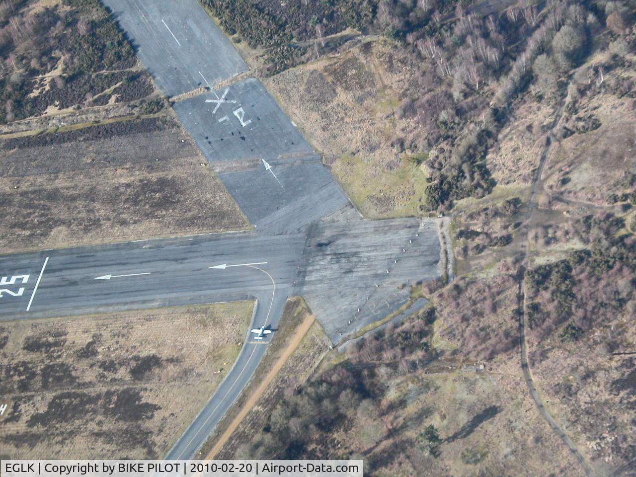 Blackbushe Airport, Camberley, England United Kingdom (EGLK) - OVER HEAD BLACKBUSHE RWY 25 THRESHOLD WITH PA-28 ENTERING RWY