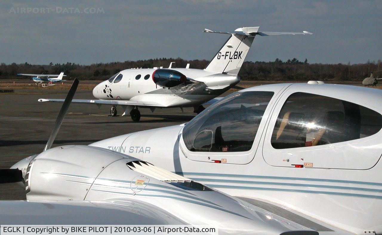 Blackbushe Airport, Camberley, England United Kingdom (EGLK) - VIEW FROM THE EASTERN BOUNDARY FENCE. DA42 G-CDXK, MUSTANG G-FLBK AND REIMS CESSNA F150M G-BFIY