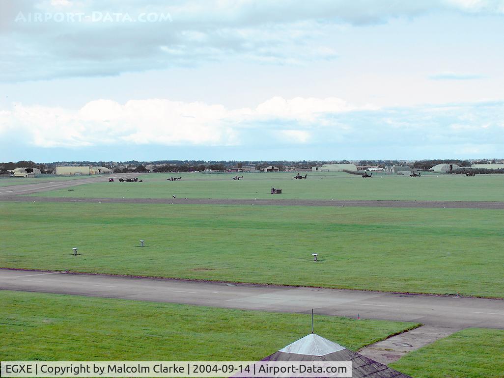 RAF Leeming Airport, Leeming Bar, England United Kingdom (EGXE) - View from Leeming's ATC tower looking NE. Two Puma's and 4 Apache's can be seen.