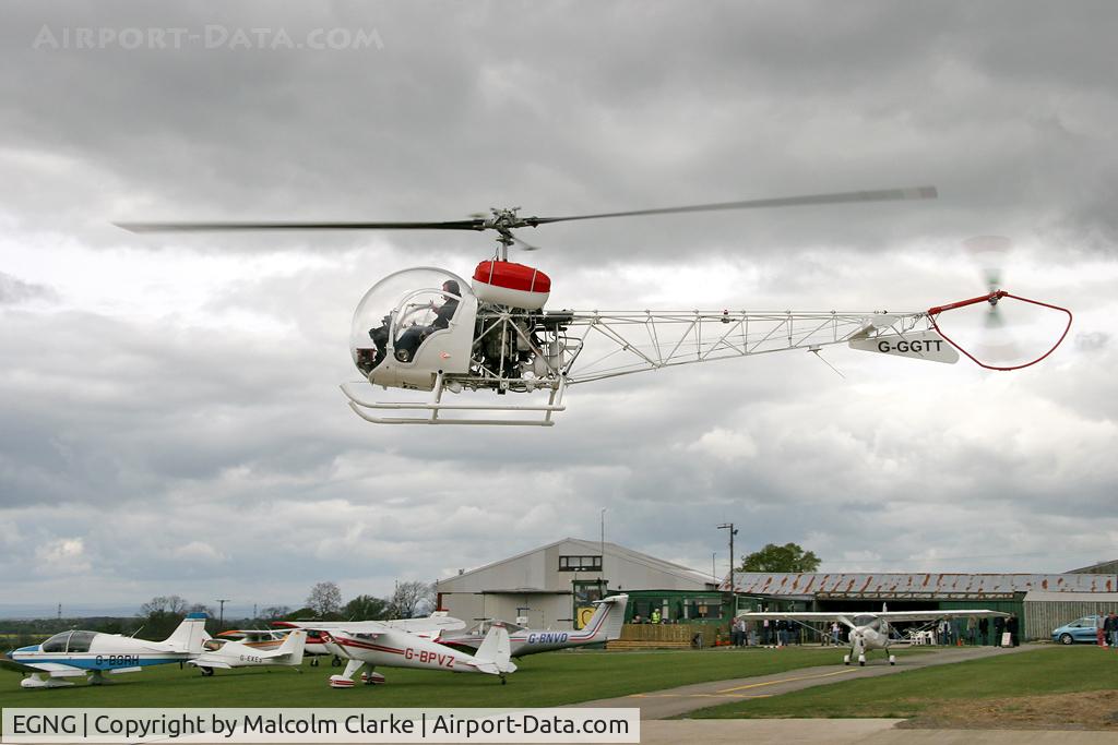 EGNG Airport - A view across Bagby Airfield as Agusta G-GGTT prepares to put down.