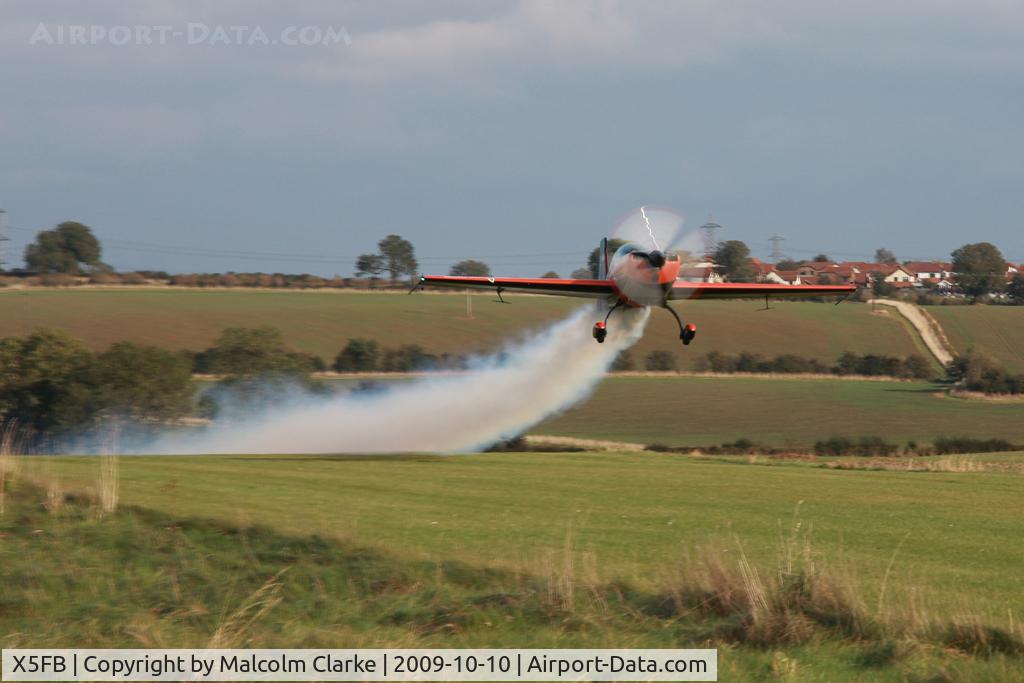X5FB Airport - Extra G-ZXEL takes off from Fishburn's 6 degree upslope making smoke.