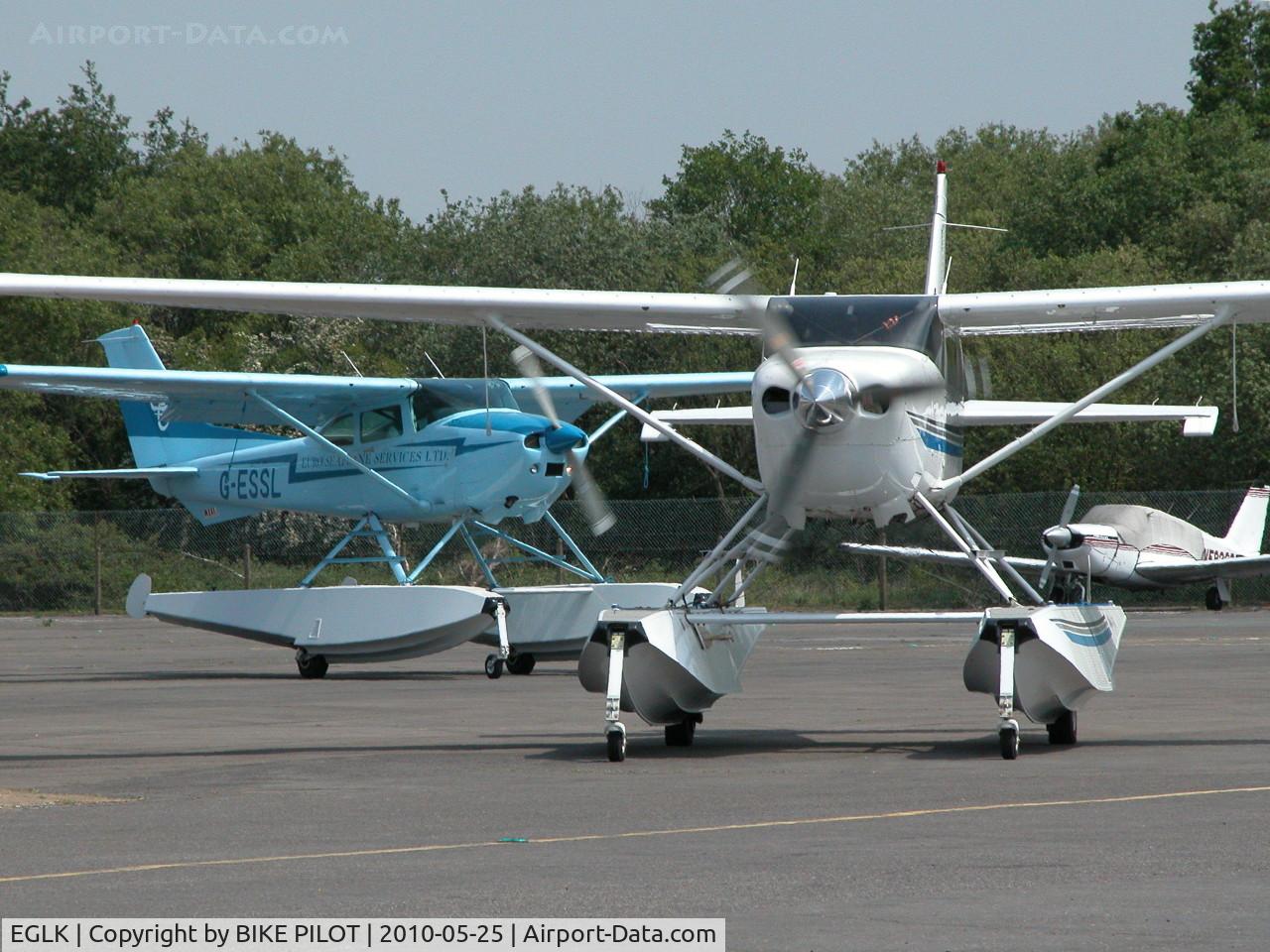 Blackbushe Airport, Camberley, England United Kingdom (EGLK) - VISITING CESSNA 206H N206MX AND RESIDENT CESSNA 182R G-ESSL TAXYING FOR DEPARTURE