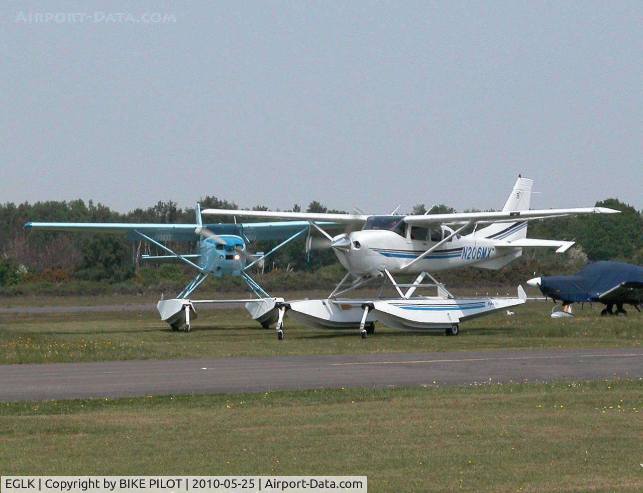 Blackbushe Airport, Camberley, England United Kingdom (EGLK) - VISITING CESSNA 206H N206MX AND RESIDENT CESSNA 182R G-ESSL TAXYING FOR DEPARTURE