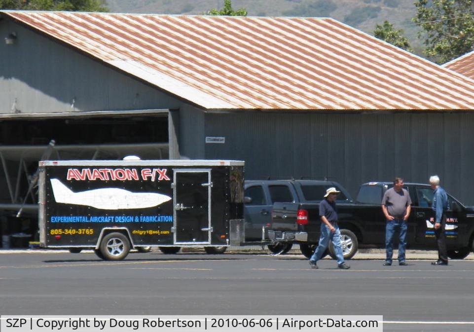 Santa Paula Airport (SZP) - AVIATION F/X trailer in tow between hangars, Experimental aircraft design & fabrication.