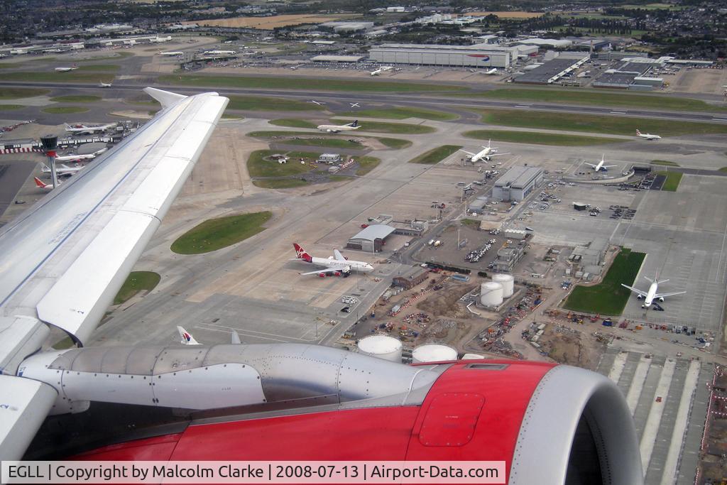 London Heathrow Airport, London, England United Kingdom (EGLL) - A view across 09R/27L and the cargo area at London Heathrow as Airbus G-DBCG takes off en route to Newcastle in July 2008.
