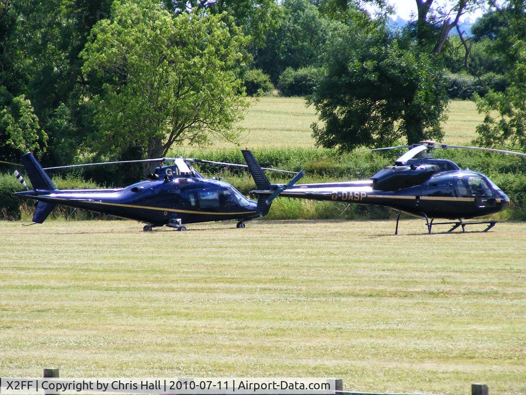 X2FF Airport - Agusta A109C G-IFRH and Aerospatiale AS355F1 Ecureuil II G-OASP being used for ferrying race fans to Silverstone for the British Grand Prix from this temporary heliport a few miles east of Bicester