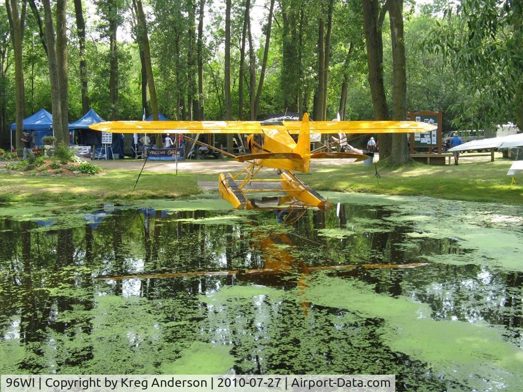 Vette/blust Seaplane Base (96WI) - A view of a Cub and some exhibitors behind it at the Vette/Blust Seaplane Base.