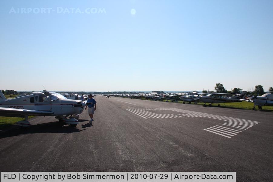 Fond Du Lac County Airport (FLD) - Looking east down RWY 9 as temporary parking ramp during Oshkosh 2010.