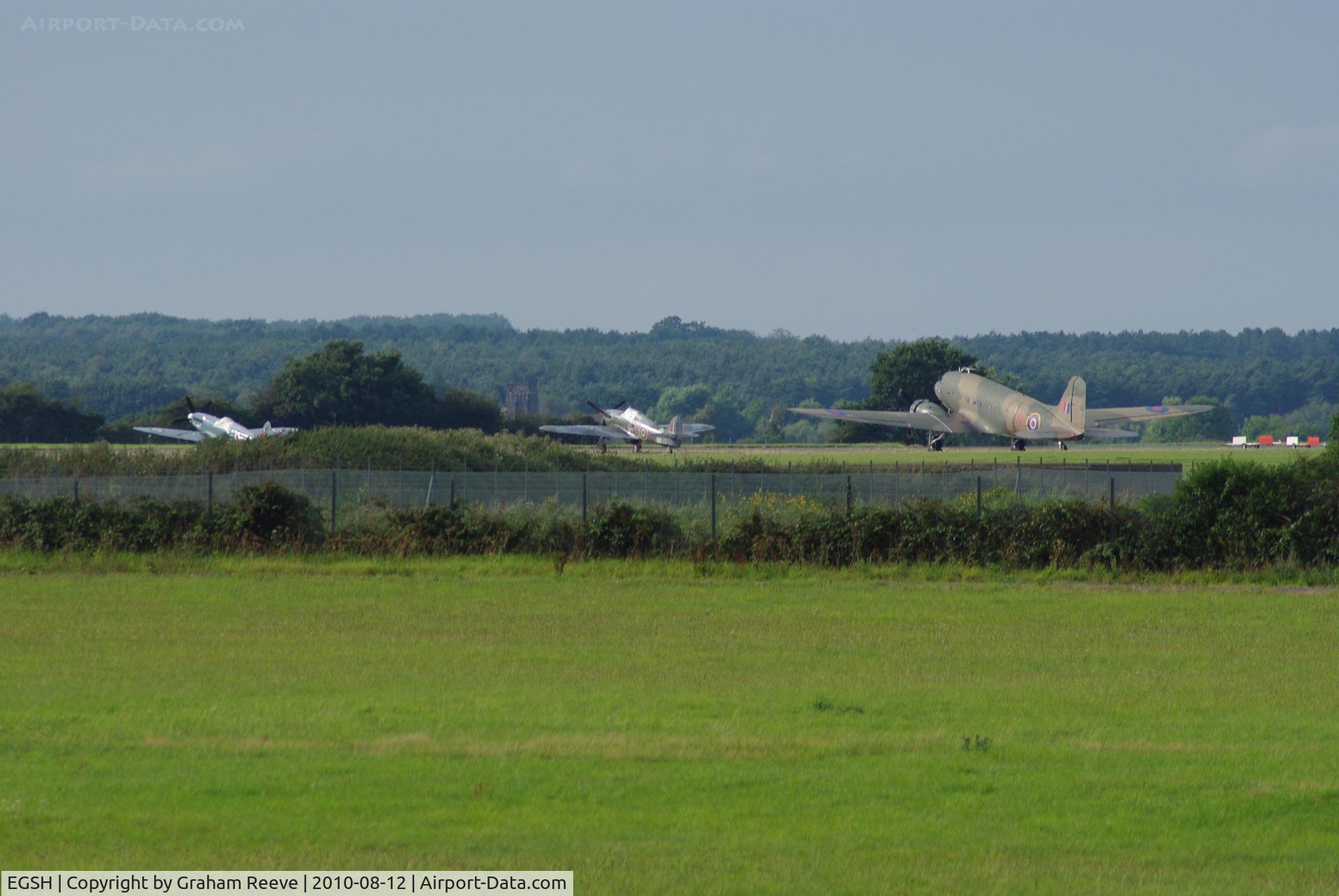 Norwich International Airport, Norwich, England United Kingdom (EGSH) - Spitfire, Hurricane and Dakota parked on the far apron of Norwich Airport.