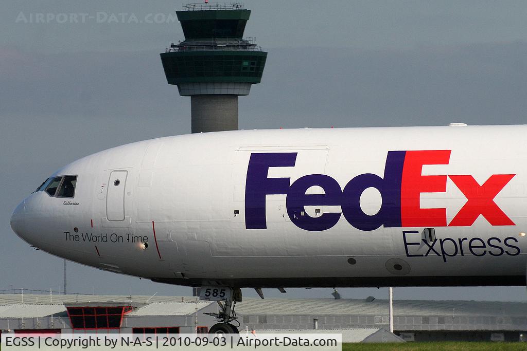 London Stansted Airport, London, England United Kingdom (EGSS) - Fed Ex MD11 passing Stansted's tower
